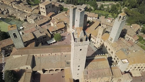 Birds flying around the big tower in the Medieval town of San Gimignano in Tuscany, Italy. photo