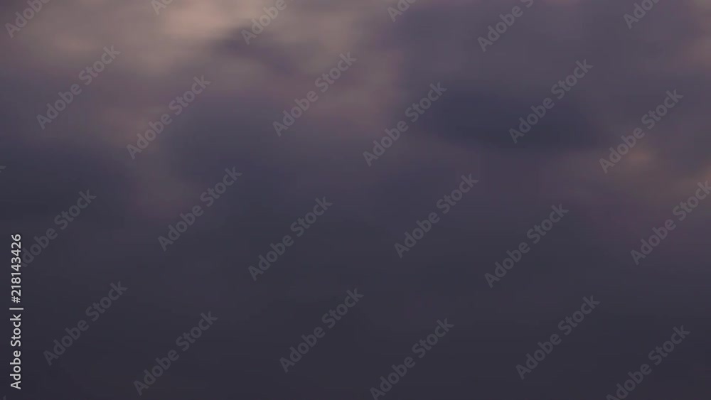 Timelapse of dark, fast moving clouds during sunset Timelapse of dark, fast moving clouds during sunset