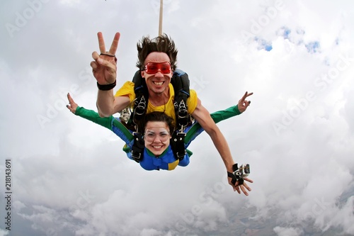 Skydiving tandem happiness on a cloudy day