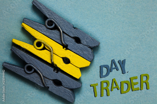 Conceptual hand writing showing Day Trader. Business photo text A person that buy and sell financial instrument within the day Gray yellow vintage clothespins clear background Holding things. photo