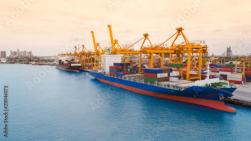 Ship container from sea port and cityscape background for import export or transportation concept.