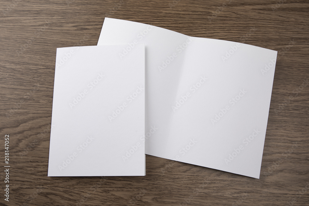 Mockup of white booklet on wooden background. Mockup of white booklet on wooden background.