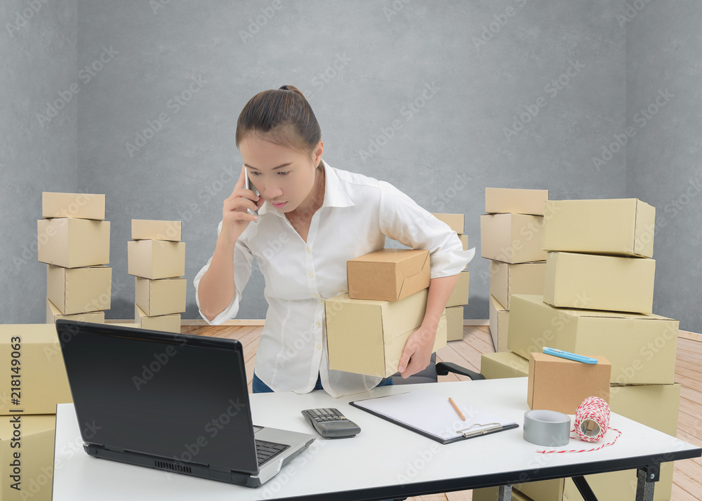 teenager owner business woman work at home with smartphone, laptop for online shopping writing the order. teenager owner business woman work at home with smartphone, laptop for online shopping writing the order.
