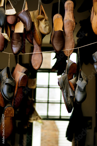 Handmade shoes hanging on display