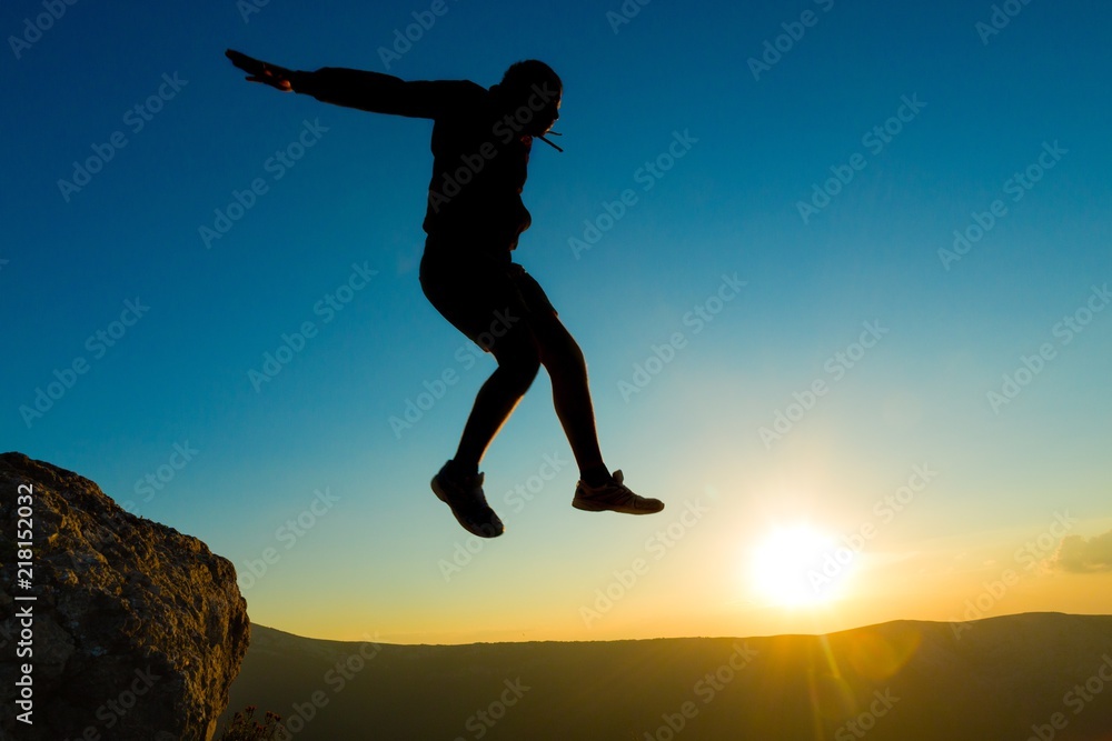 Man Jumping on Rocks Man Jumping on Rocks