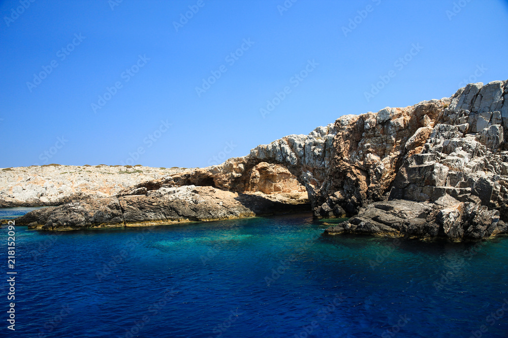 A cave in the deep blue sea of Astypalaia island in Greece