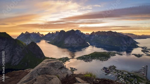 Timelapse of midnight sun hiding behind the beautiful peaks of Lofoten Islands, Norway.