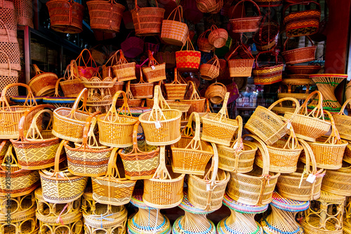 bamboo basketwork product the famous souvenir of Thailand, such as straw bags, basketwork, wicker baskets handmade in local material shop at the traditional street market.