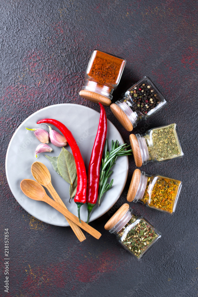 Fototapeta premium Colorful spices and herbs for cooking background and design top view. Flat lay