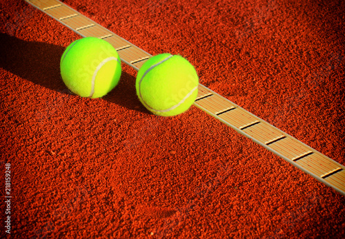 Tennis balls on a tennis clay court © Željko Radojko