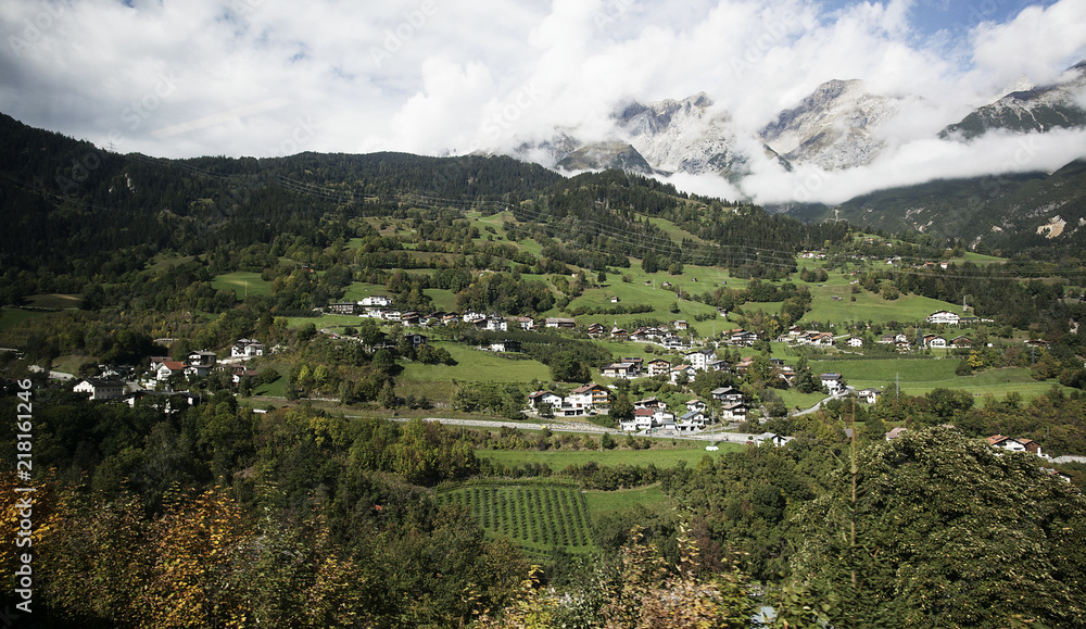 View of beautiful village in the middle of mountain from train in Austria