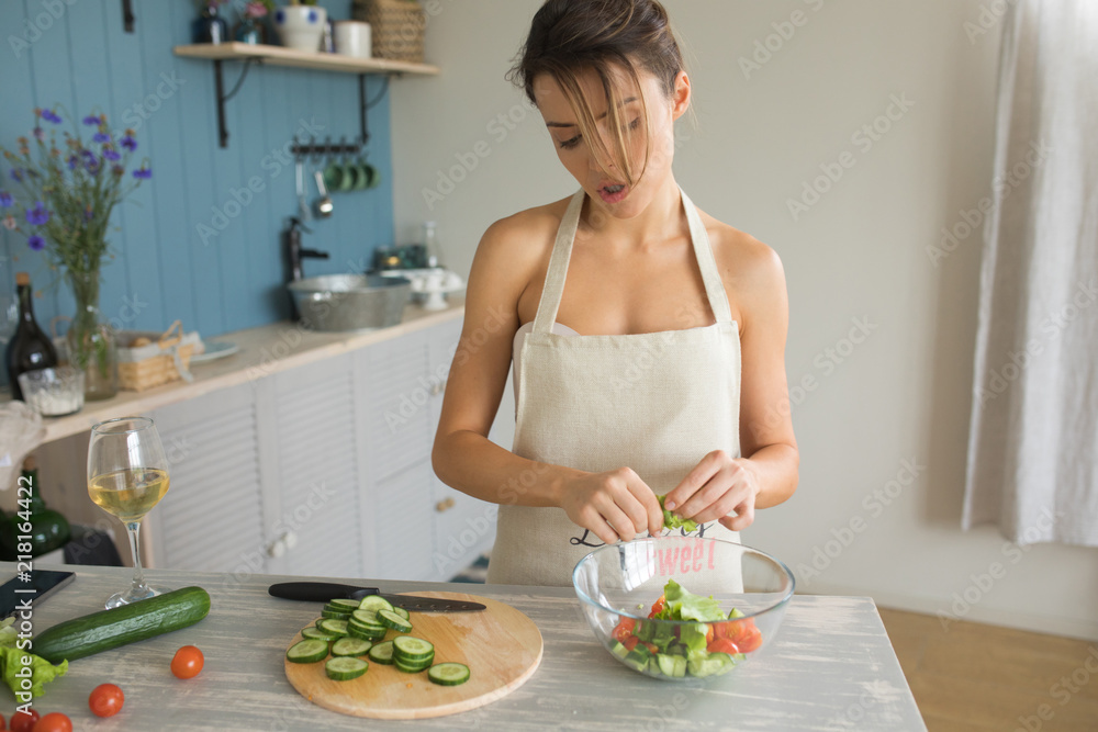 Woman preparing salad in the kitchen. Woman Cooking. Healthy Food - Vegetable Salad.