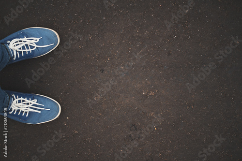 Sneakers on urban grunge background of asphalt © spaxiax