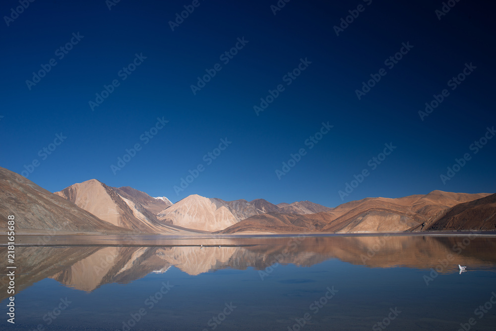 Pangong lake with blue sky and mountains background.Ladakh, India