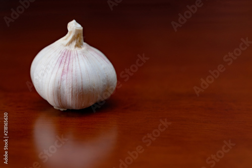 garlic cloves on wooden table