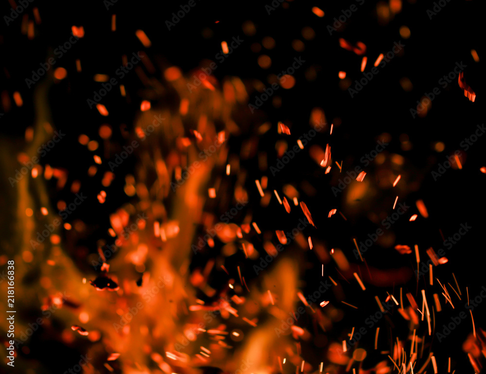 flame of fire with sparks on a black background flame of fire with sparks on a black background