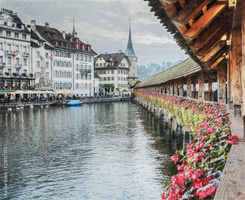 Old wooden Chapel Bridge with beautiful flowers in Lucerne, Switzerland