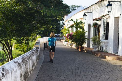 A female tourist is walking throug the streets of Mompos - Mompos/ Magdalena, Colombia photo