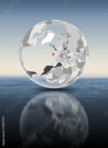 Ireland on translucent globe above water