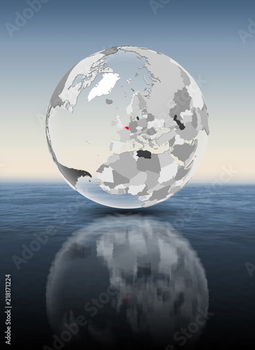 Belgium on translucent globe above water