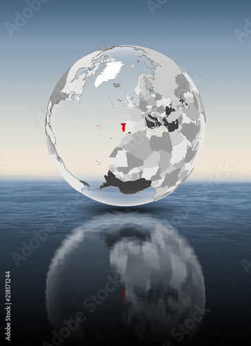 Portugal on translucent globe above water