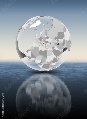Bosnia and Herzegovina on translucent globe above water