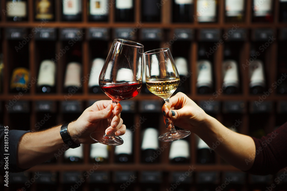 Man and woman drinking red and white wine together - obrazy, fototapety, plakaty 