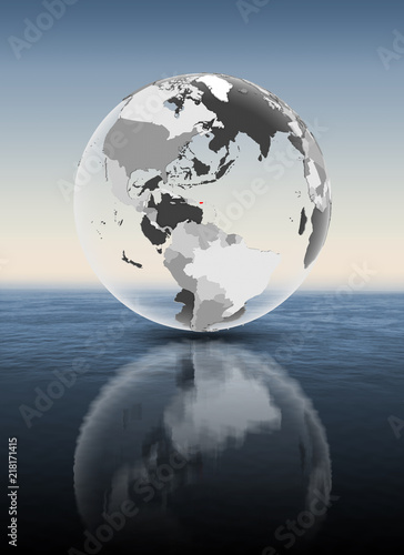 Puerto Rico on translucent globe above water