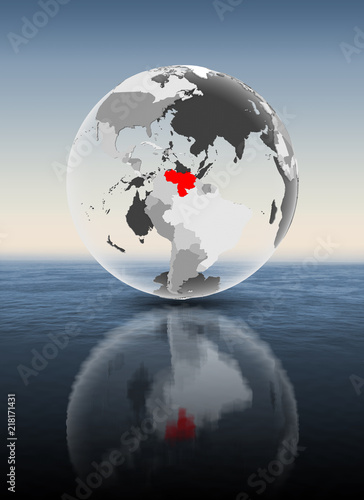 Venezuela on translucent globe above water