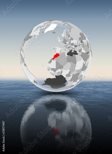 Morocco on translucent globe above water