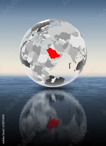 Saudi Arabia on translucent globe above water