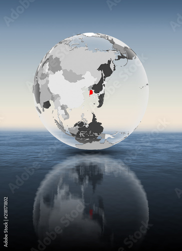Fototapeta Naklejka Na Ścianę i Meble -  South Korea on translucent globe above water