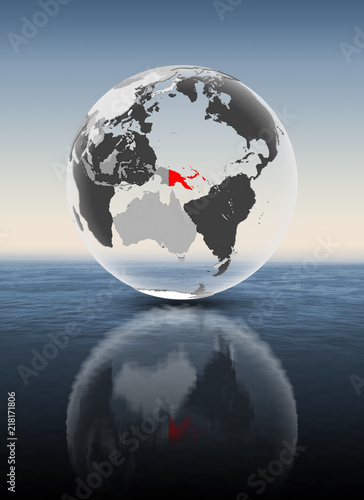 Papua New Guinea on translucent globe above water