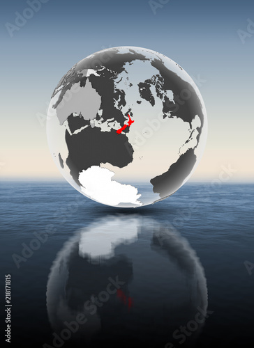 New Zealand on translucent globe above water