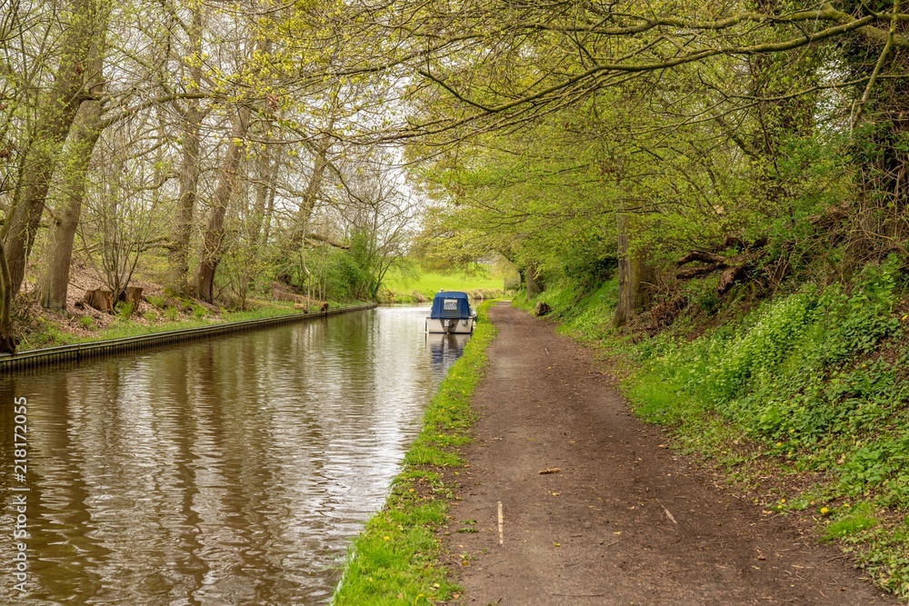 The Llangollen Canal near Ellesmere, Shropshire, England, UK - with a boat on the shore The Llangollen Canal near Ellesmere, Shropshire, England, UK - with a boat on the shore