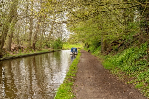 The Llangollen Canal near Ellesmere, Shropshire, England, UK - with a boat on the shore