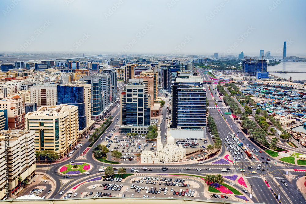 Fototapeta premium Aerial view on Deira City Center in Dubai, UAE, on a summer day with expensive hotels and roads. Scenic travel background.