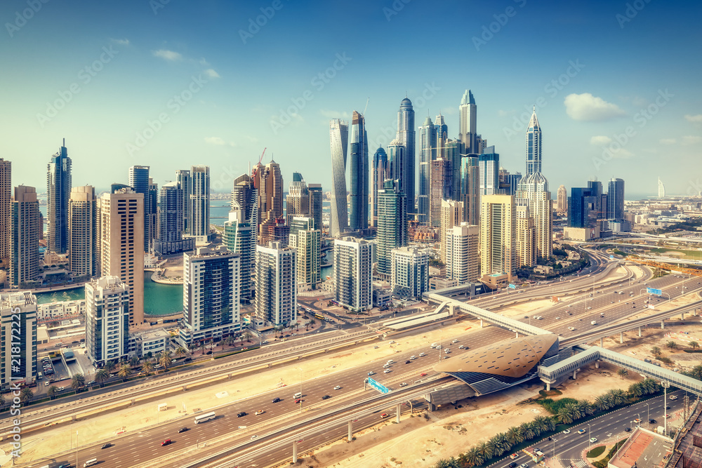 Aerial daytime skyline of Dubai Marina, UAE, with skyscrapers in the distance. Scenic travel background.