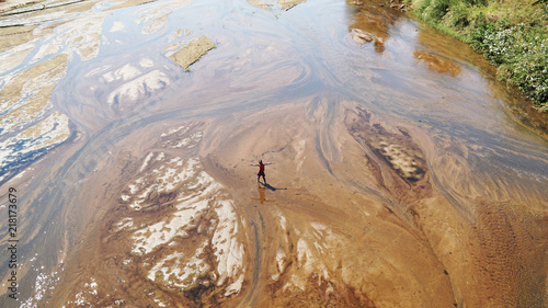 small girl greatings from a muddy river in madagascar, concept of africa united and travels. love for nature. photo