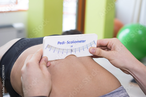 Scoliosis Screening with Pedi-Scoliometer on young person spine photo