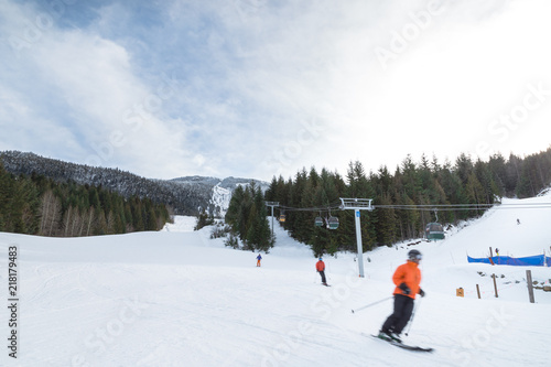 Blurred skiers going downhill on Whistler Mountain.