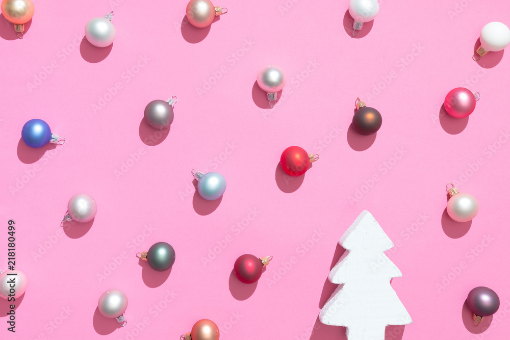 Creative Christmas baubles decoration pattern with christmas tree and pink background. Minimal flat lay concept.