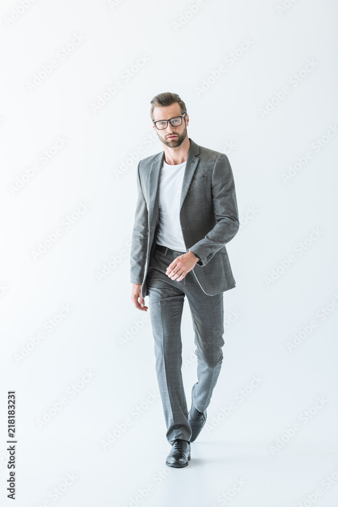 elegant stylish businessman walking in gray suit, isolated on white