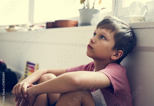 Young boy with depression face photo
