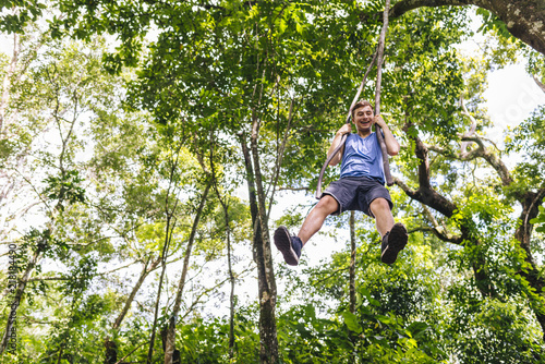 A teenagert swings like a tarzan through the jungle - Minca/ Magdalena /Colombia