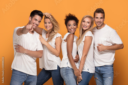 Group of beautiful friends posing together in studio. © neonshot