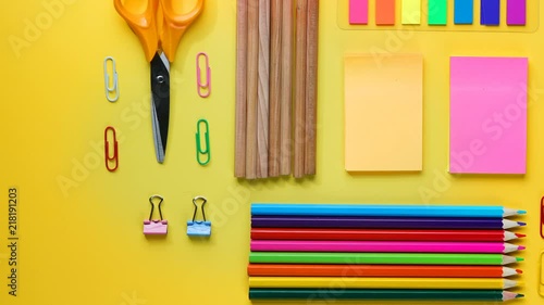 Back To School Text on Torn Paper. School Stationary Flat Lay on Yellow Background Timelapse 4K