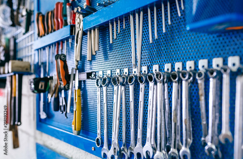 Detail of motorcycle workshop tools board with wrenches in the foreground