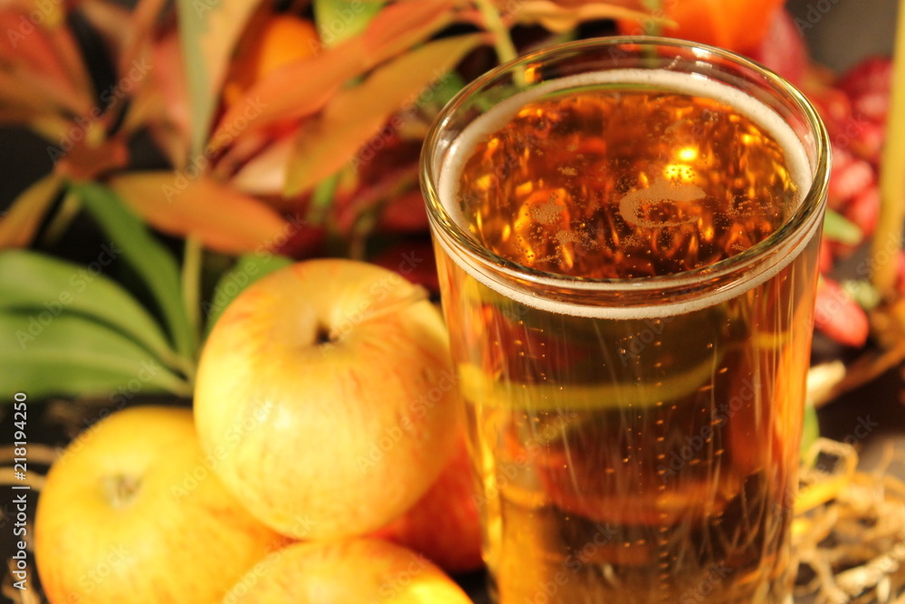 cider in glass surrounded by apples
