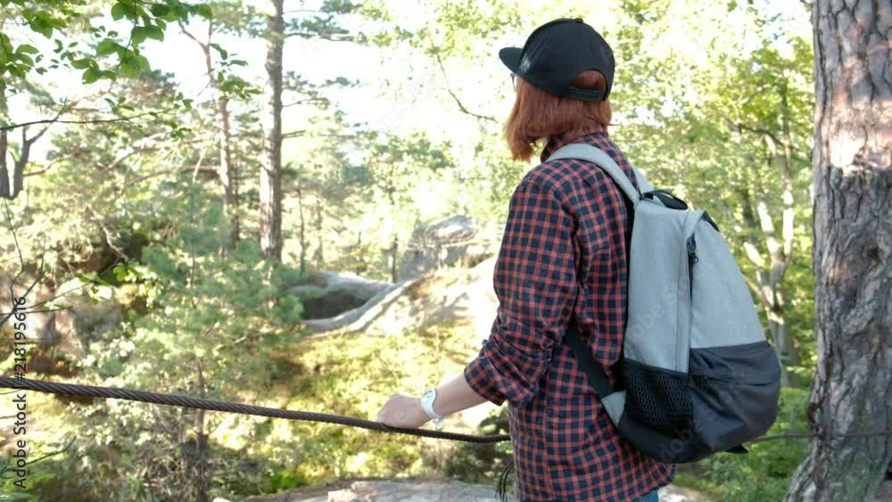 Hiker with Backpack Hiking on top of a mountain with sun flares. Young Woman Healthy Active Lifestyle. Adventure in Nature. 4K Hiker with Backpack Hiking on top of a mountain with sun flares. Young Woman Healthy Active Lifestyle. Adventure in Nature. 4K